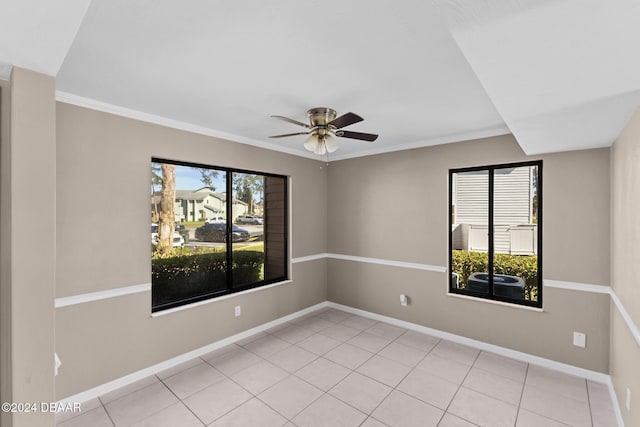 spare room featuring light tile patterned floors, ceiling fan, and ornamental molding