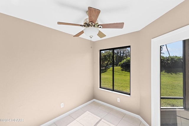 empty room featuring light tile patterned floors and ceiling fan