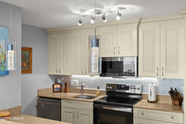 kitchen with hanging light fixtures, sink, appliances with stainless steel finishes, and tasteful backsplash