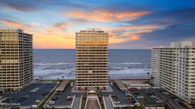 exterior space featuring a beach view and a water view