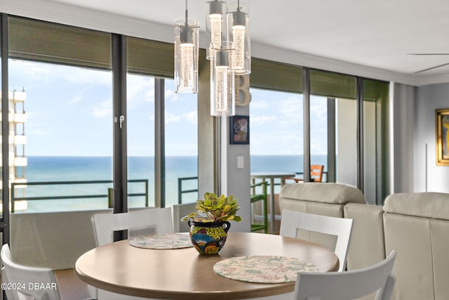 dining area with a water view and floor to ceiling windows