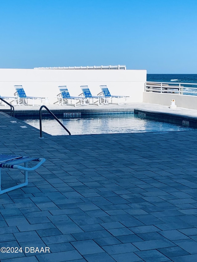 view of pool featuring a water view