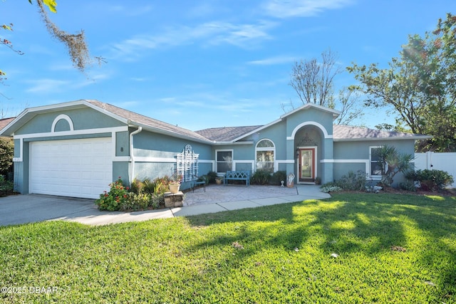 ranch-style home featuring a garage, concrete driveway, a front lawn, and stucco siding