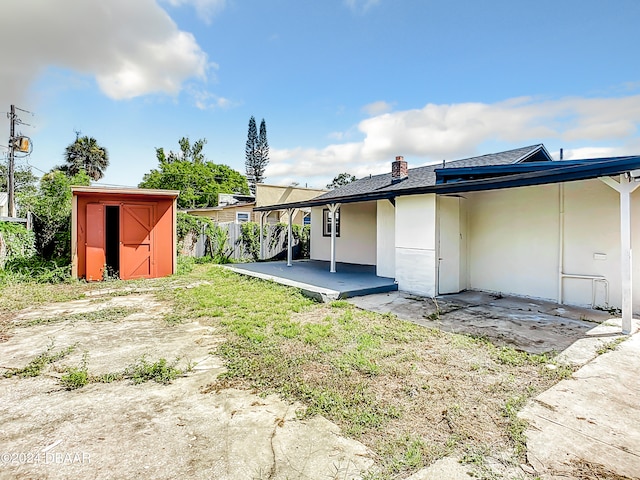 736 N Segrave St, Daytona Beach, FL 32114 - back of property featuring a patio area and a shed