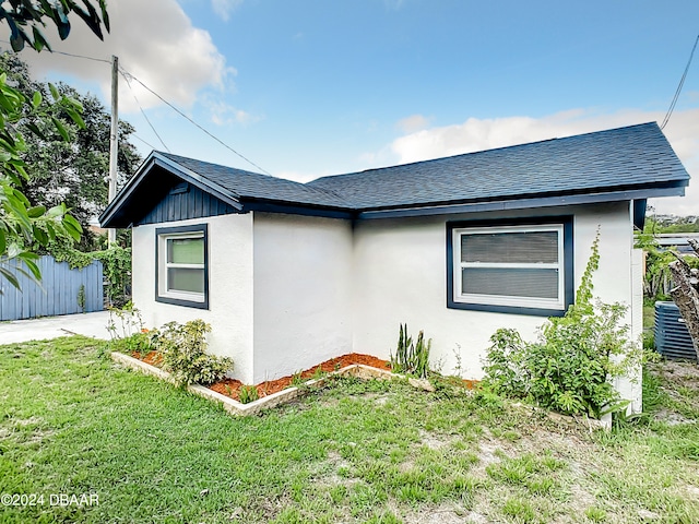 736 N Segrave St, Daytona Beach, FL 32114 - view of side of property featuring central air condition unit and a yard