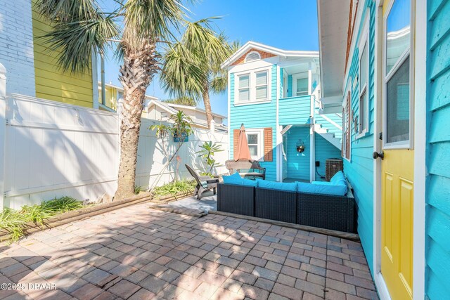 view of patio with an outdoor hangout area, central AC, and fence