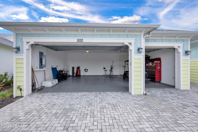500 Barefoot Life Ln, Daytona Beach, FL 32124 - garage featuring electric panel and decorative driveway