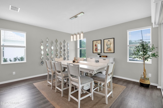 500 Barefoot Life Ln, Daytona Beach, FL 32124 - dining space featuring dark wood-type flooring, healthy amount of natural light, and a chandelier