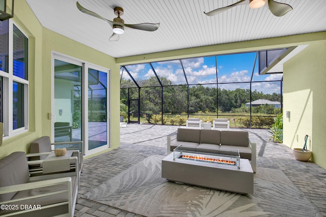 500 Barefoot Life Ln, Daytona Beach, FL 32124 - view of patio featuring ceiling fan, an outdoor living space with a fire pit, a lanai, and view of scattered trees