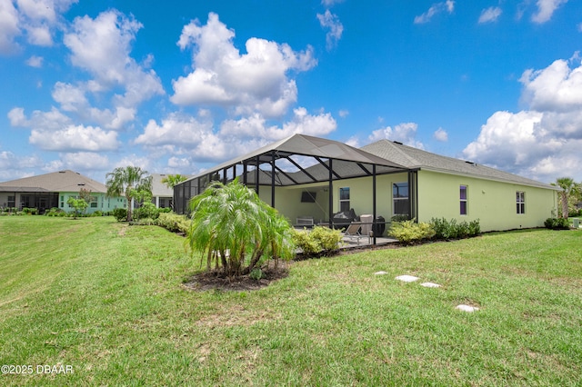 500 Barefoot Life Ln, Daytona Beach, FL 32124 - rear view of house with a yard, stucco siding, a patio, and a lanai