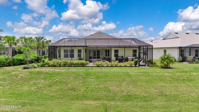 500 Barefoot Life Ln, Daytona Beach, FL 32124 - rear view of property with a lawn, a patio area, and glass enclosure