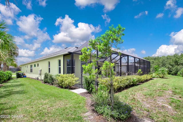 500 Barefoot Life Ln, Daytona Beach, FL 32124 - rear view of property with stucco siding, a yard, and a lanai