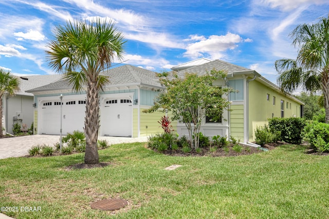 500 Barefoot Life Ln, Daytona Beach, FL 32124 - ranch-style home featuring an attached garage, a front lawn, and decorative driveway