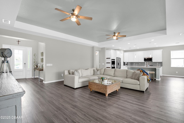500 Barefoot Life Ln, Daytona Beach, FL 32124 - living room with a tray ceiling, a ceiling fan, dark wood-style flooring, and recessed lighting