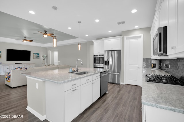 500 Barefoot Life Ln, Daytona Beach, FL 32124 - kitchen featuring stainless steel appliances, dark wood finished floors, white cabinetry, decorative backsplash, and recessed lighting