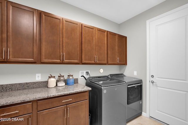 500 Barefoot Life Ln, Daytona Beach, FL 32124 - laundry area featuring cabinet space, washer and dryer, and light tile patterned floors