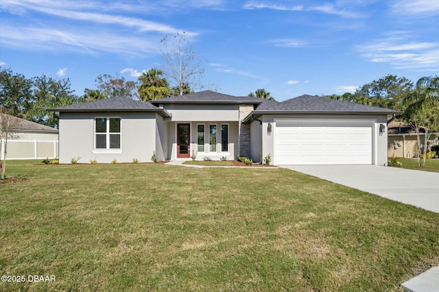 prairie-style house featuring a garage and a front lawn