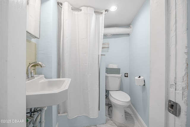 401 N Oleander Ave, Daytona Beach, FL 32118 - bathroom with toilet, marble finish flooring, a shower with shower curtain, a sink, and baseboards