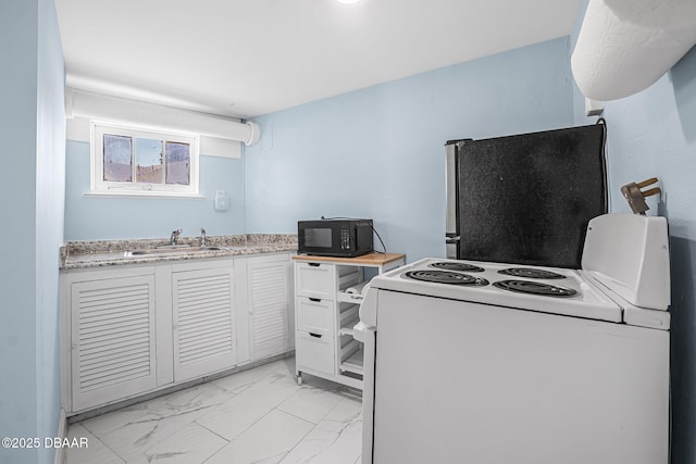 401 N Oleander Ave, Daytona Beach, FL 32118 - kitchen featuring electric stove, freestanding refrigerator, black microwave, a sink, and light marble finish flooring