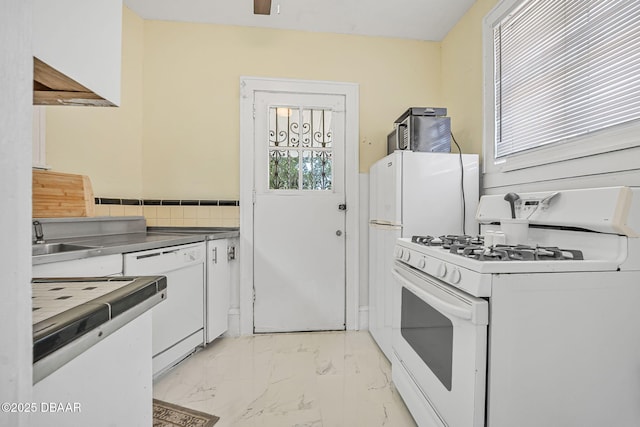 401 N Oleander Ave, Daytona Beach, FL 32118 - kitchen featuring white appliances, white cabinets, light marble finish floors, and a sink