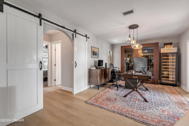 home office with light hardwood / wood-style flooring