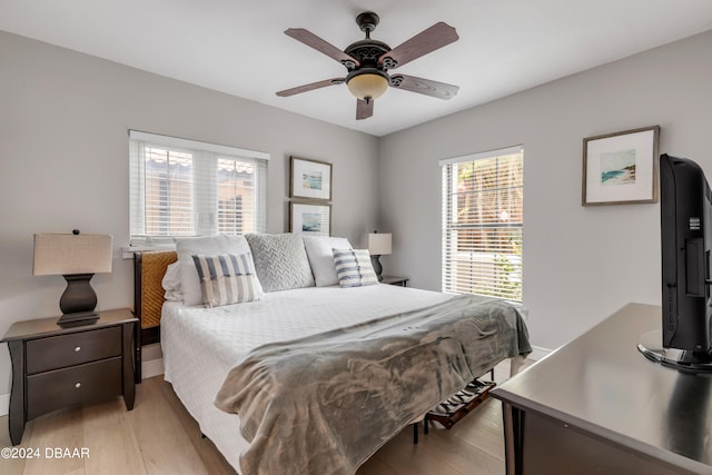 bedroom with light hardwood / wood-style flooring and ceiling fan