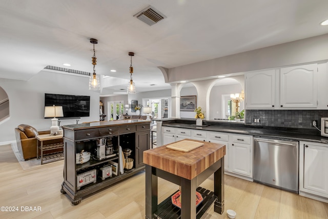 kitchen featuring white cabinetry, backsplash, hanging light fixtures, light hardwood / wood-style flooring, and dishwasher