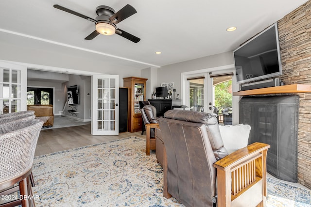 living room featuring french doors, light hardwood / wood-style floors, and ceiling fan