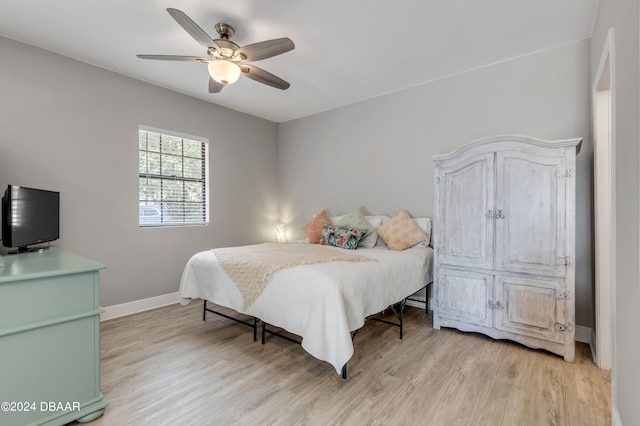 bedroom with ceiling fan and light wood-type flooring