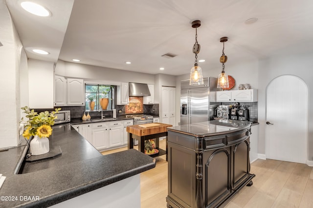 kitchen with tasteful backsplash, sink, and light hardwood / wood-style floors