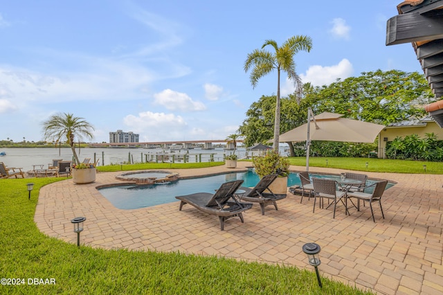 view of swimming pool featuring a lawn, an in ground hot tub, a water view, and a patio area