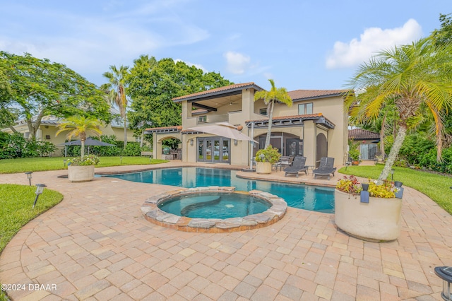 view of pool with a lawn, an in ground hot tub, and a patio area