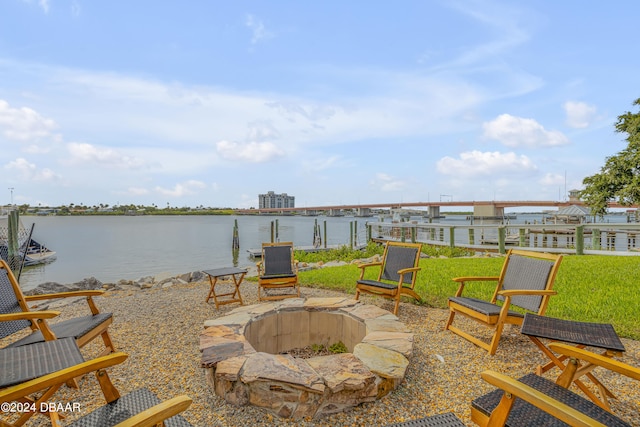 view of patio featuring a fire pit and a water view