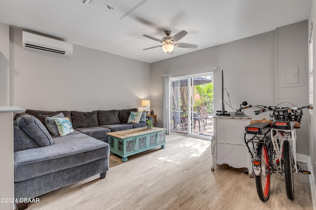 living room with ceiling fan, wood-type flooring, and a wall mounted air conditioner