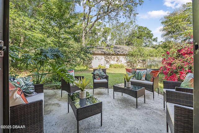 view of patio / terrace featuring an outdoor living space and fence