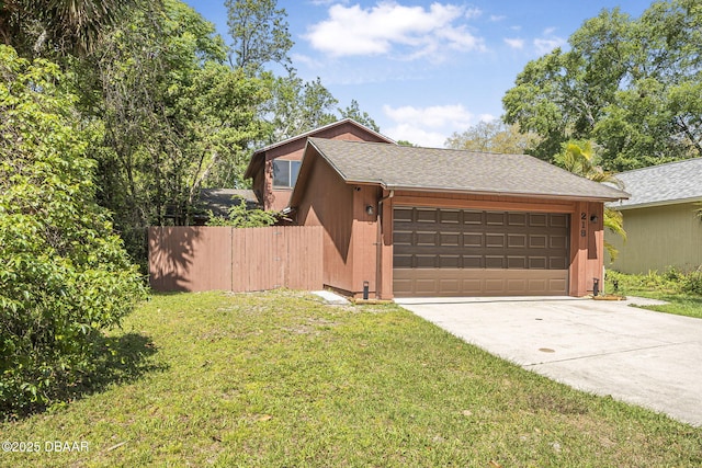 view of side of property with driveway, a shingled roof, fence, a yard, and a garage