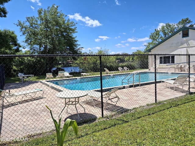 community pool featuring fence and a patio area