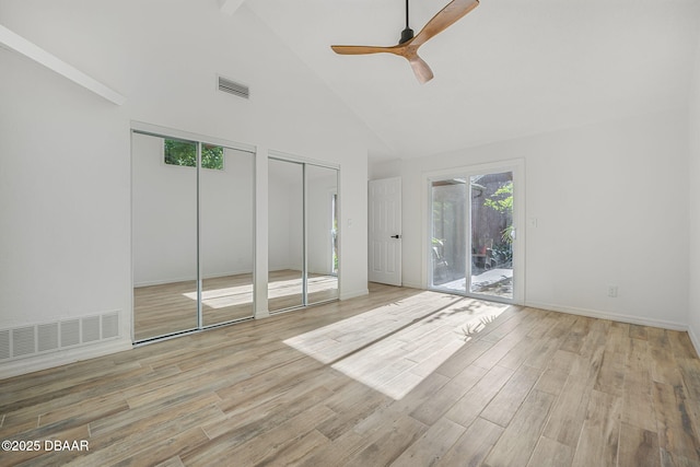 unfurnished bedroom with visible vents, multiple closets, high vaulted ceiling, and access to outside