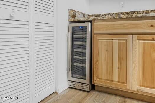 details with wood finished floors and wine cooler