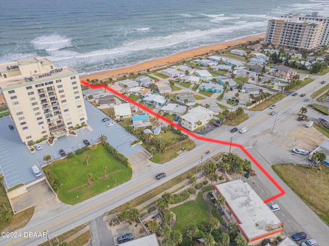 bird's eye view featuring a water view and a view of the beach