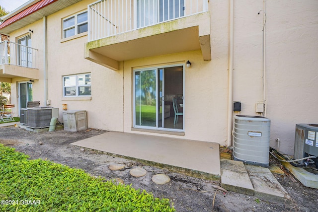 back of house with a patio area, cooling unit, and a balcony