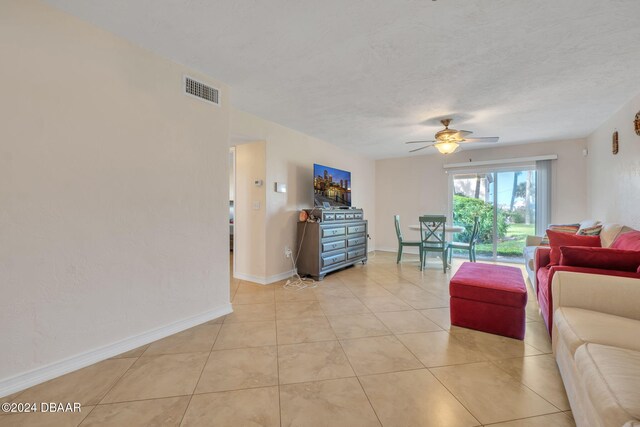 tiled living room with ceiling fan