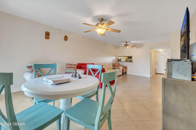 tiled dining area featuring ceiling fan