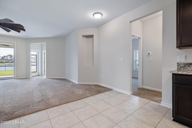 133 Wood Stork Ln, Palm Coast, FL 32164 - unfurnished room with light carpet, healthy amount of natural light, a ceiling fan, and baseboards