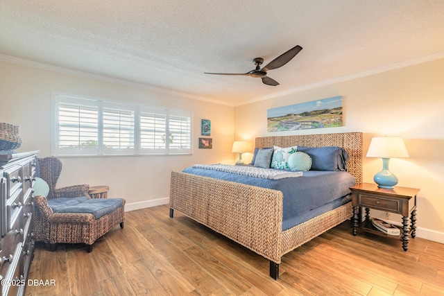 bedroom with light wood-style floors and crown molding