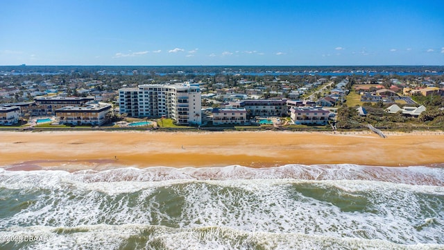 drone / aerial view with a water view and a beach view