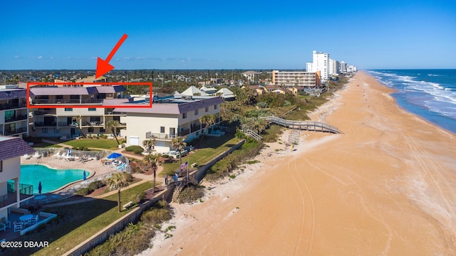 bird's eye view featuring a view of the beach and a water view