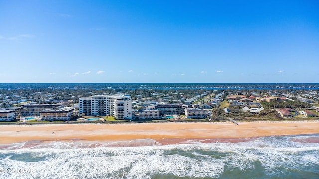 drone / aerial view with a water view and a beach view