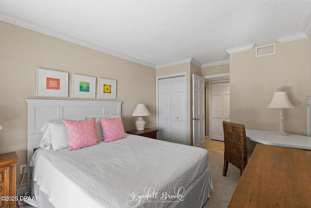 bedroom featuring light carpet, ornamental molding, a closet, and a textured ceiling