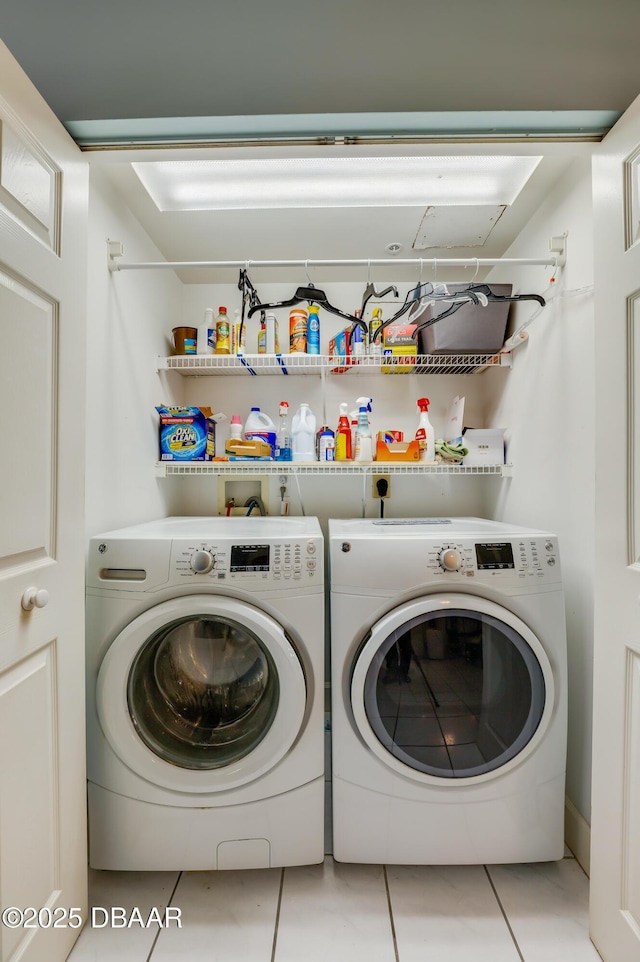 laundry room with light tile patterned floors and washing machine and dryer